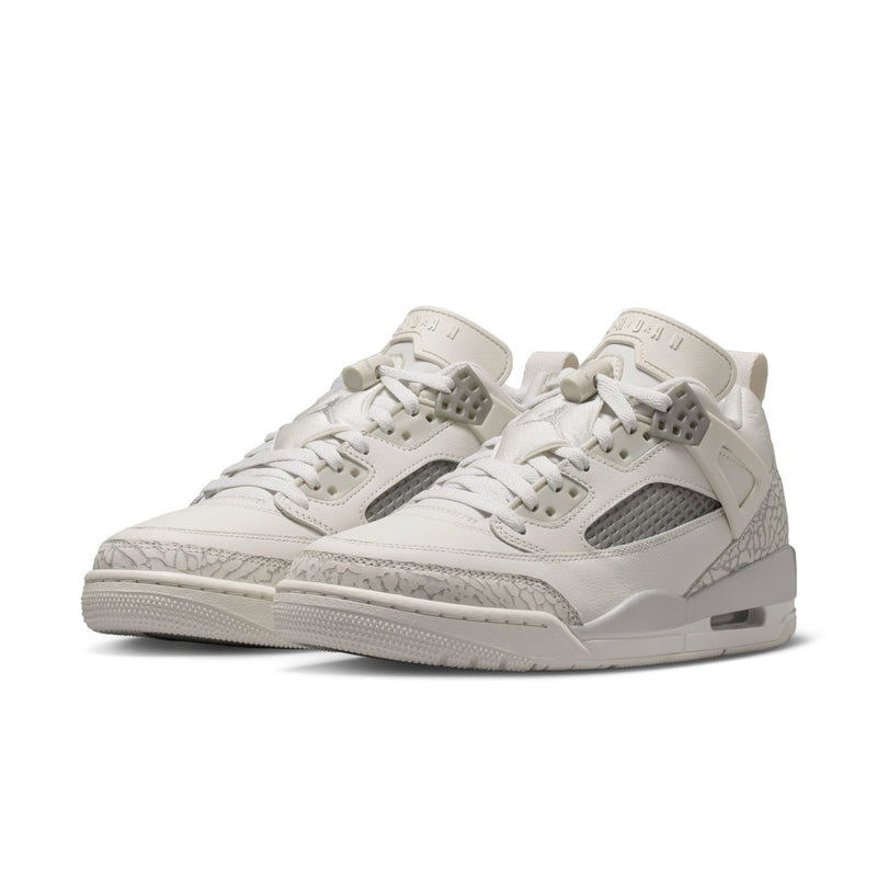 White low-top sneakers with gray mesh panels, lace-up design, and textured overlays