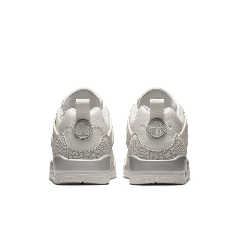 White low-top sneakers with textured heel panels and light gray outsole