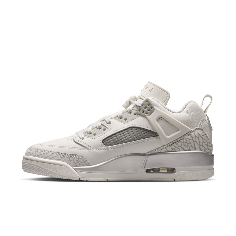 White low-top sneaker with snake-texture panel, gray mesh, and visible air window