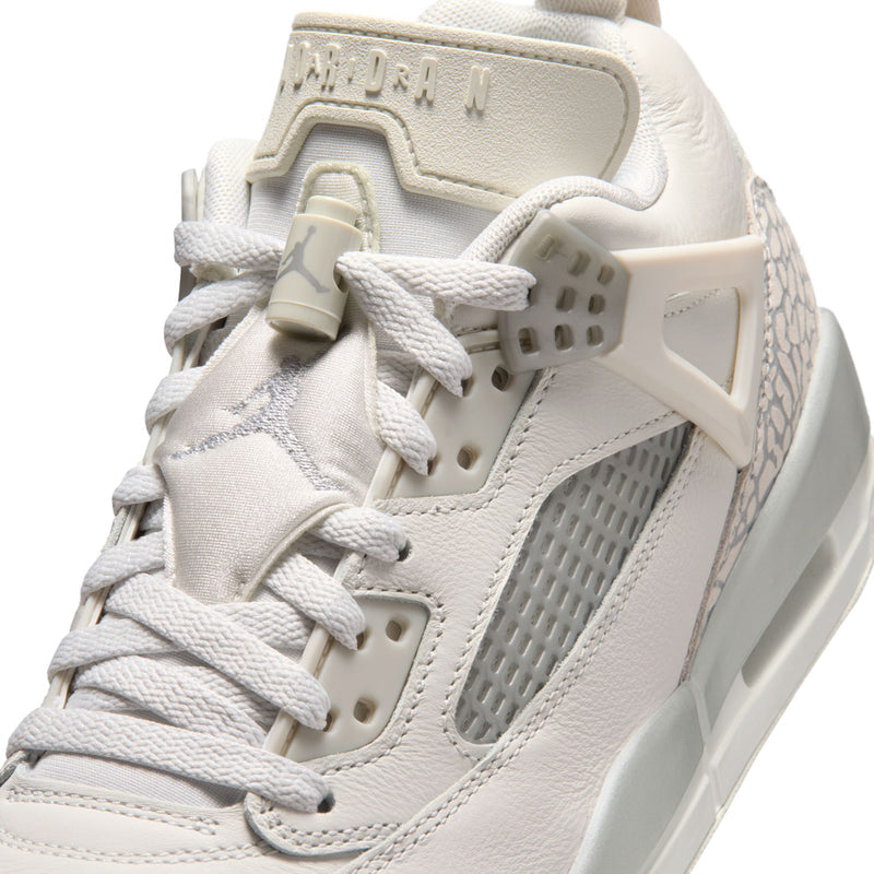 White low-top sneaker with lace-up, gray mesh, and textured heel overlay