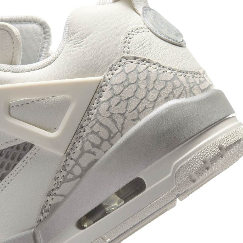 White low-top sneaker with snake-pattern side panel and air window on sole