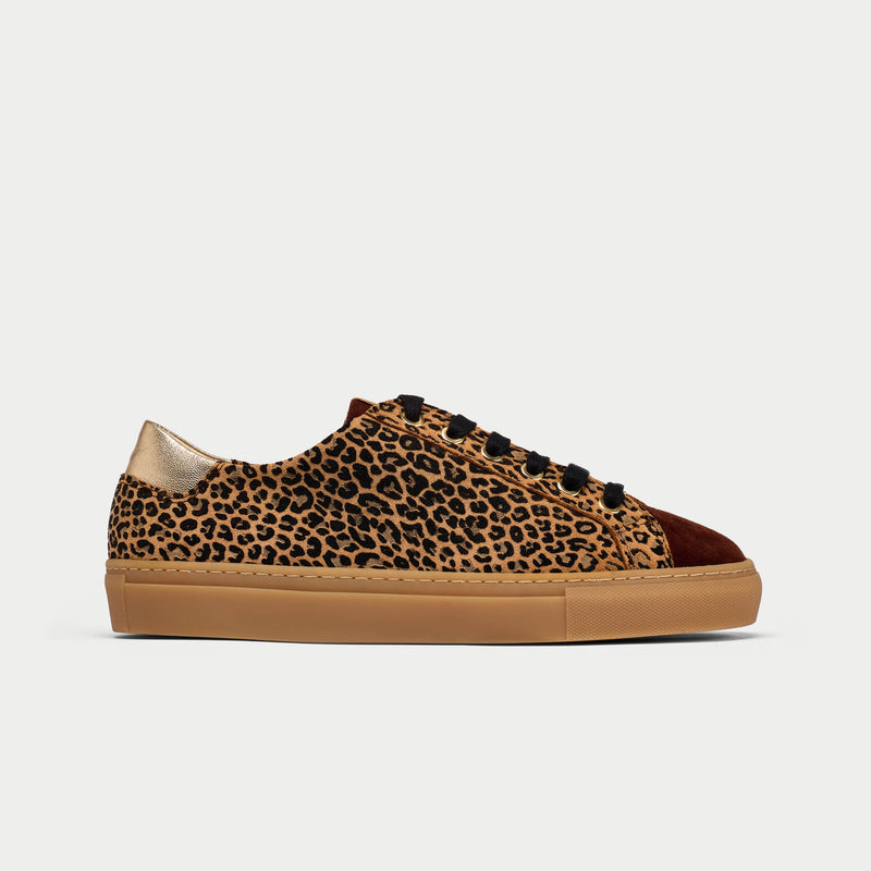 Leopard print sneaker with brown sole on a light gray background