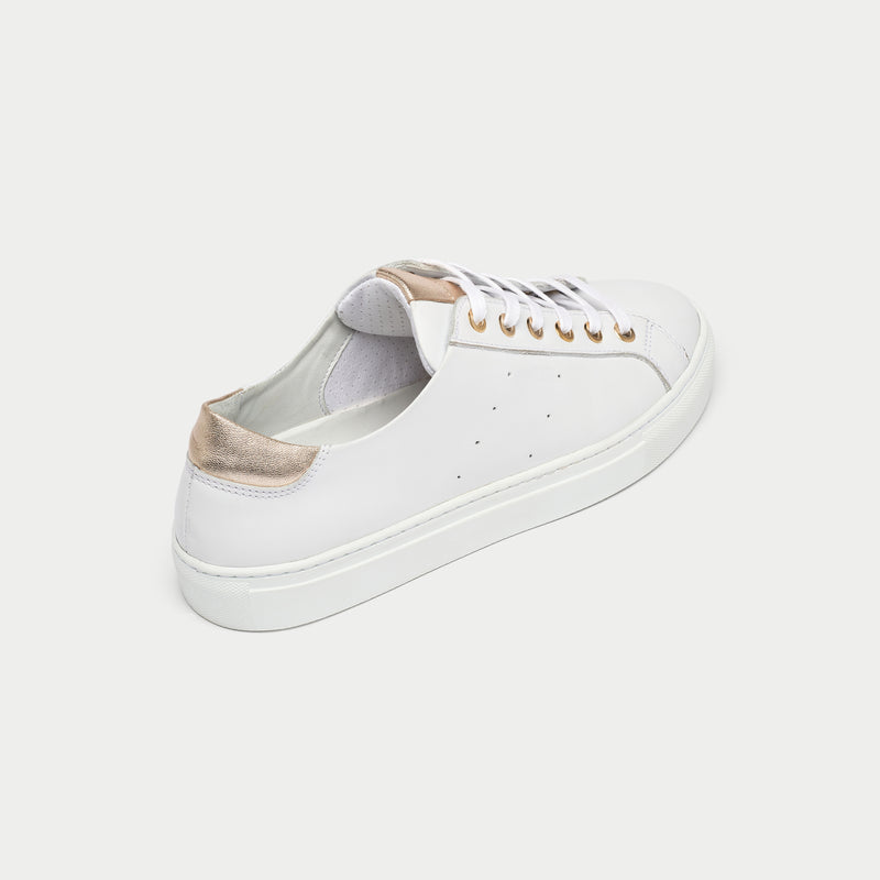 White sneaker with gold accents on a white background back close up