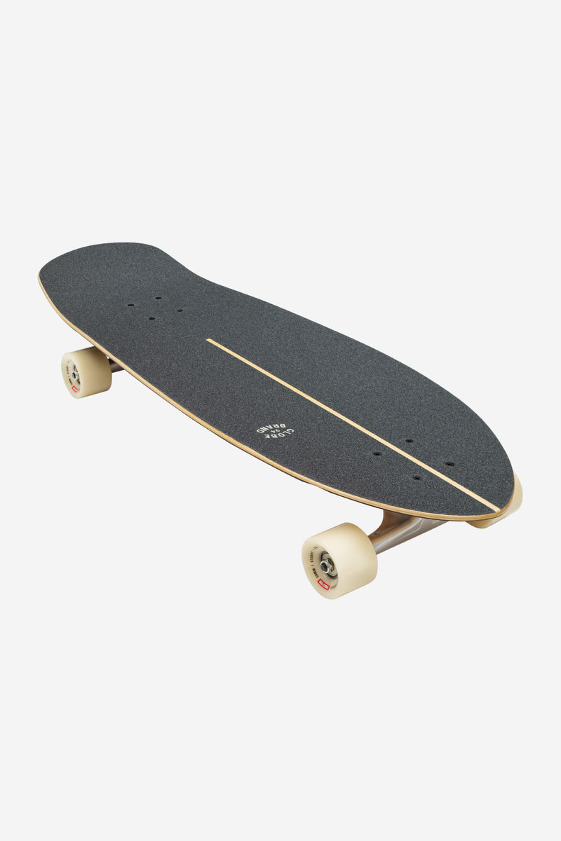 Stubby Cruiserboard 30 Inner Savage with dark grip tape and beige wheels, angled deck view