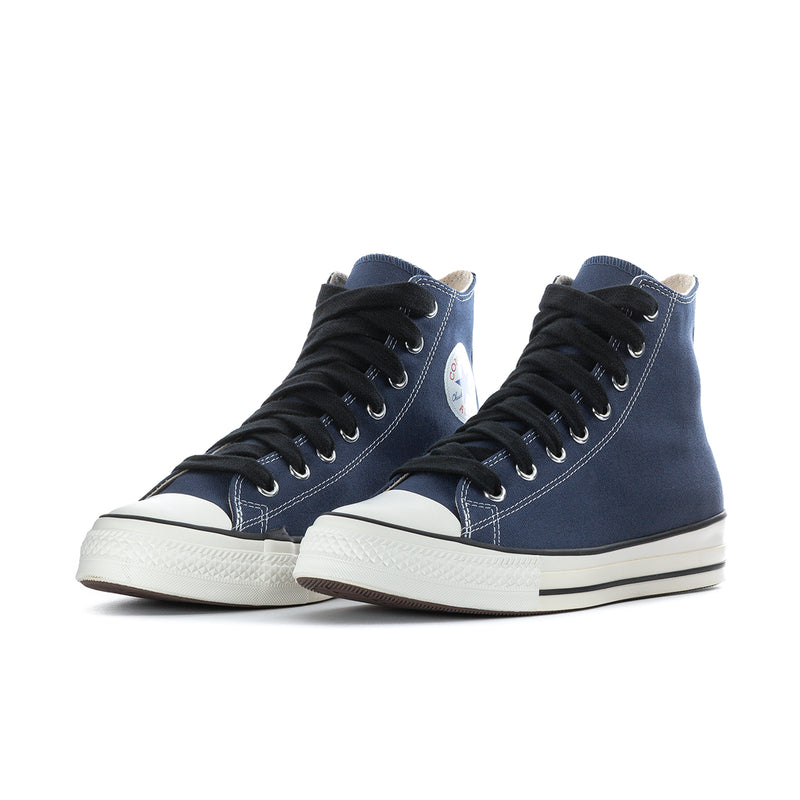 Pair of men's navy high-top sneakers with black laces and white rubber sole