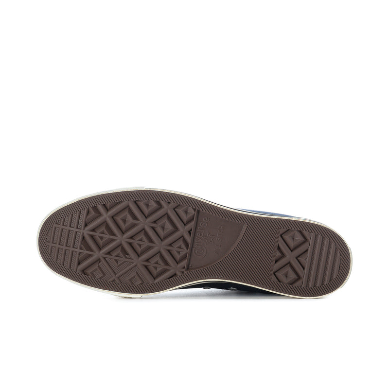 Outsole of navy men's high-top sneakers with textured brown rubber tread