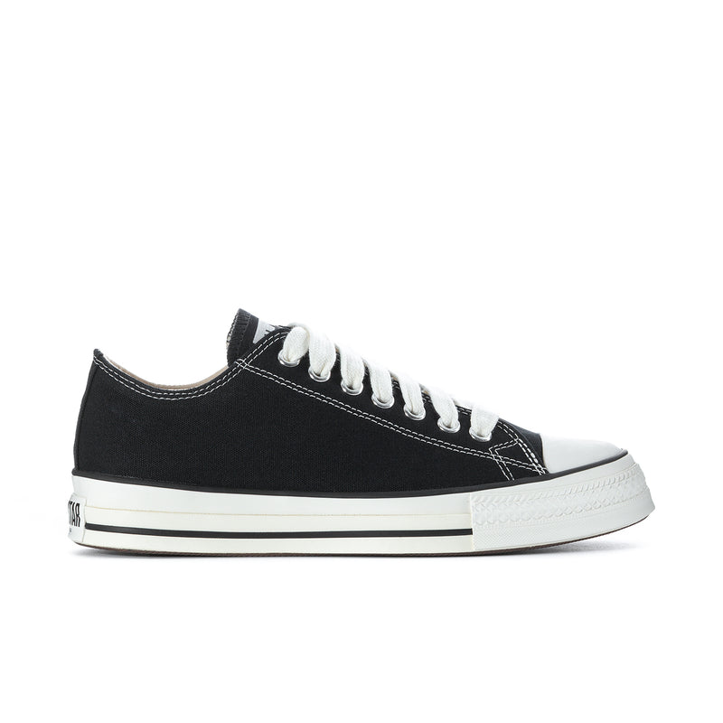 Black low-top canvas sneakers with white laces and off-white rubber toe cap