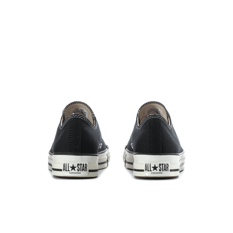 Black low-top sneakers with off-white soles and 'All Star Converse' heel lettering