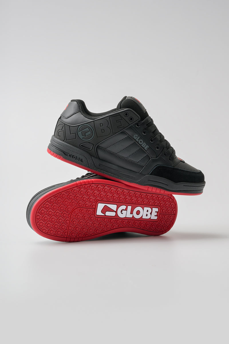 Tilt skate shoe in black red charcoal with red outsole and embossed Globe branding along the side