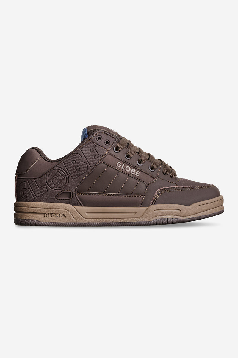 Tilt brown skate shoe with blue tartan lining and embossed Globe branding on the side