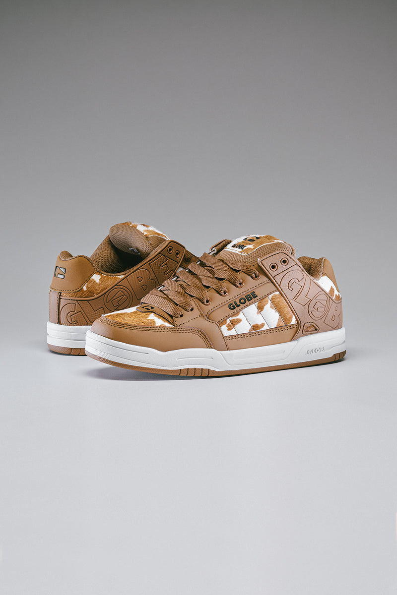 Pair of Tilt Brown White Cow skate shoes with cowhide panels shown from the side.