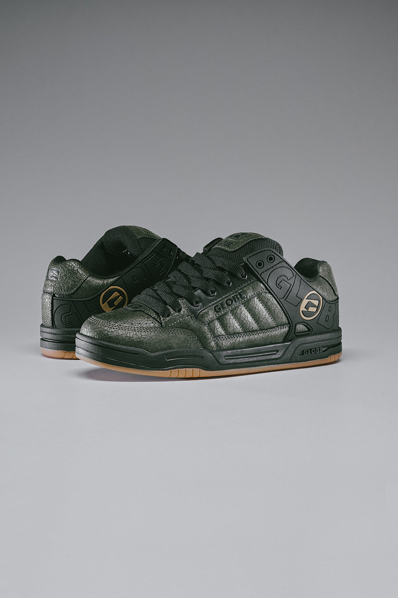 Side view of Globe Tilt Distressed Leather skate shoe in grey with molded collar and S-Trac tread
