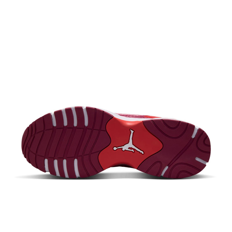 Outsole view of berry pink running shoes with white traction pods and Jordan logo