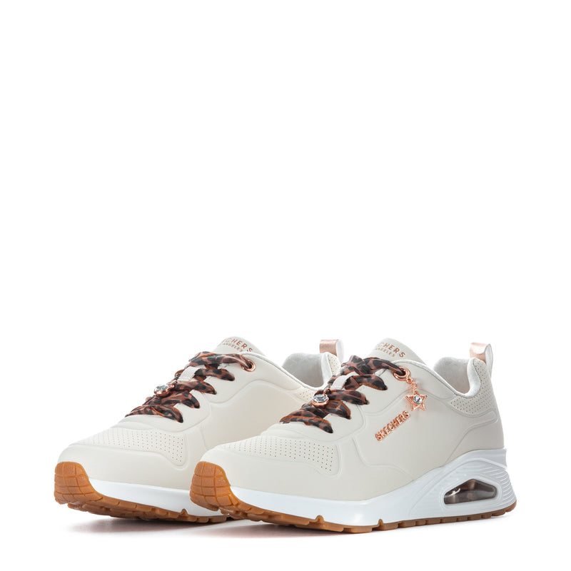 Youth white sneaker front view with leopard laces and rose-gold logo detail