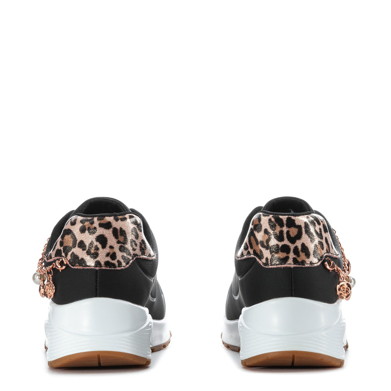 Black youth sneaker with leopard heel patch, white midsole, rear lace-up