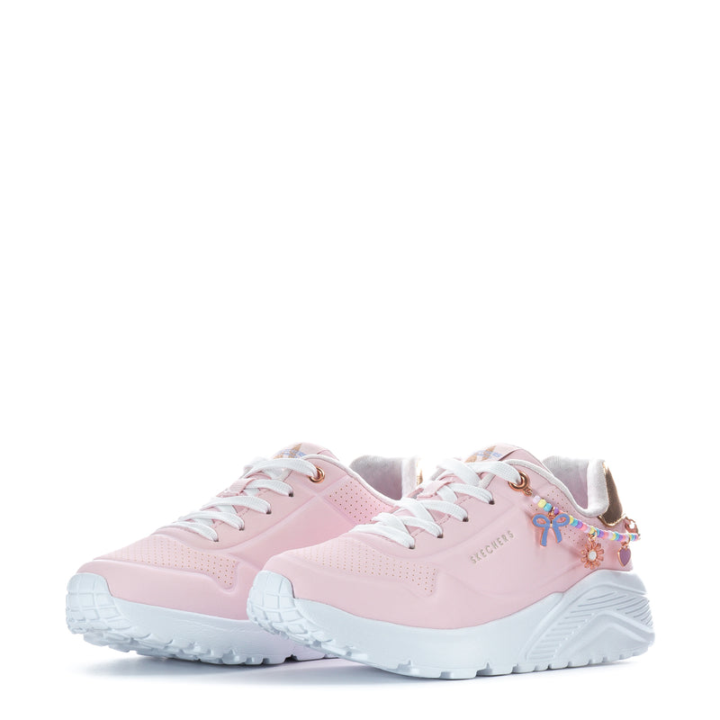 Kids pink sneakers, front view with colorful charm on side