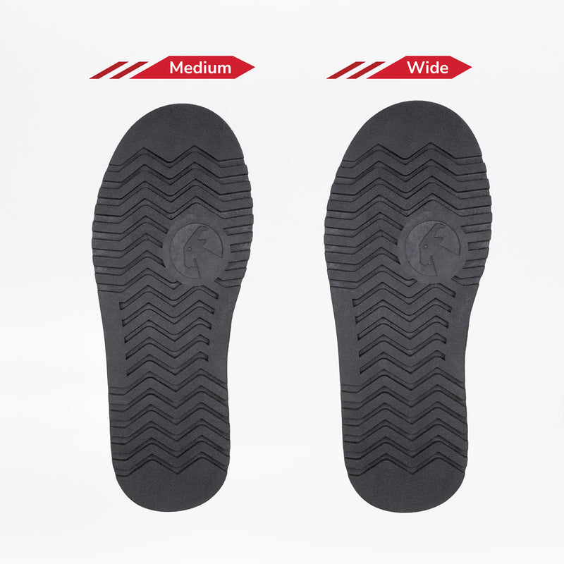 Two black shoe soles from the BILLY Footwear Women's Black BILLY Cozy Slipper are shown side by side, labeled Medium and Wide. Both have similar tread patterns and a full wrap zipper, but differ in width on a white background.