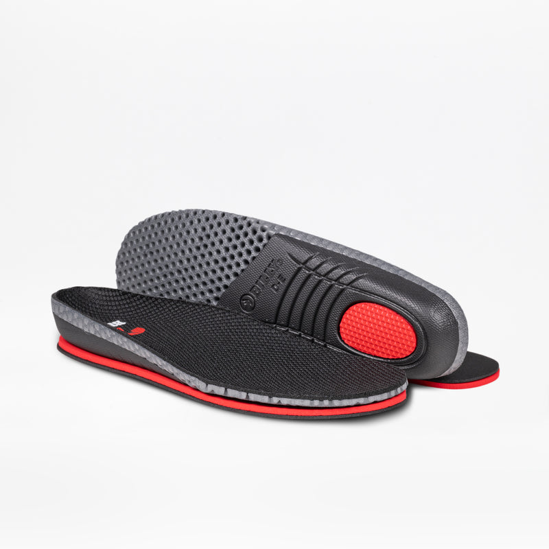 Two black insoles with gray sides and red accents, shown flat and propped to reveal texture and cushioning. Designed for Women's Black Leather BILLY Comfort Luxe sneakers by BILLY Footwear, they offer sporty, ergonomic comfort that's sensory-friendly.