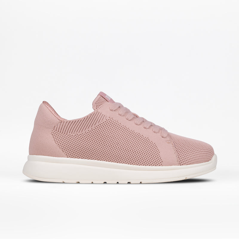 A blush Women's Comfort Knit sneaker by BILLY Footwear featuring a mesh knit upper, medial zipper, laces, and a white rubber sole is displayed on a plain white background.