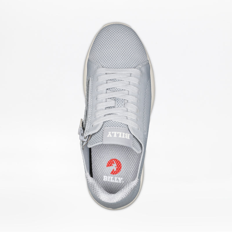 A top view of the Women's Grey BILLY Comfort Knit by BILLY Footwear shows white laces, a medial zipper, and "BILLY" branding on the tongue and insole with a red circular logo. This breathable sneaker combines style with convenience.