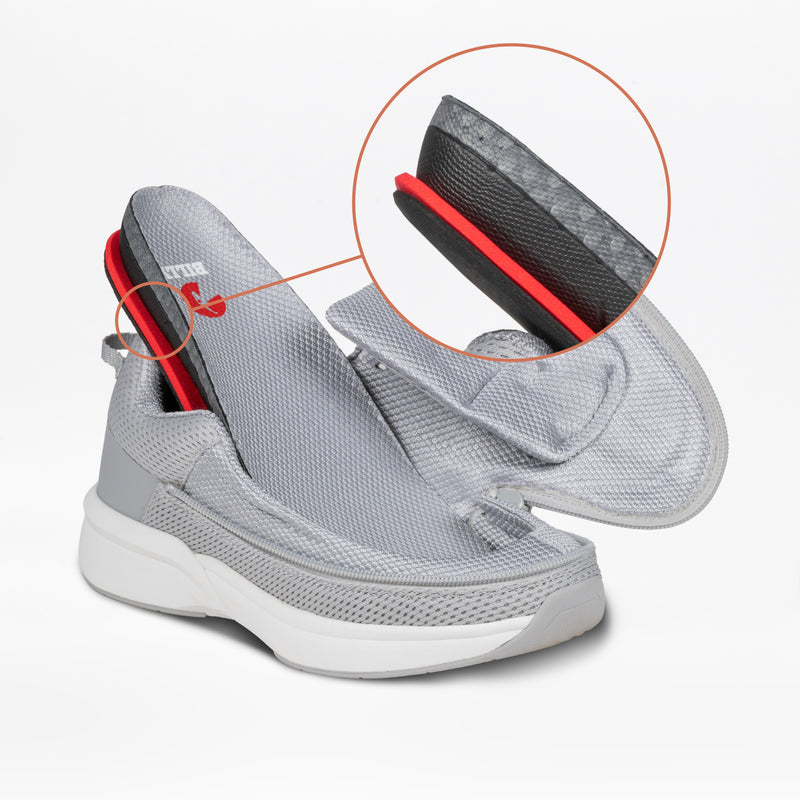 The Women's Grey BILLY Limitless by BILLY Footwear features an adjustable-depth upper lifted to reveal the insole. A magnified inset highlights the red and black layered heel cushioning, underscoring its sensory-friendly design.