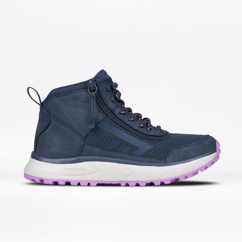 The Women's Navy/Purple BILLY Inclusion Trail Boot by BILLY Footwear features a zippered side for easy on/off, patterned laces, mesh and leather accents, plus a white sole with purple tread. Shown on a plain white background.