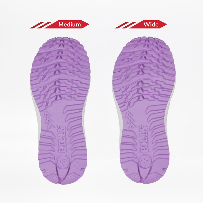Two lavender shoe soles from the BILLY Footwear Women's Navy/Purple Inclusion Trail Boot are shown side by side on a white background. The left sole is marked Medium, and the right Wide, highlighting their width difference.