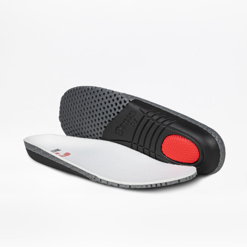 Two shoe insoles from the Women's White/Tan/Black BILLY Comfort DZ High by BILLY Footwear: one shows a textured black sole with a red heel, while the other displays the white and gray upper—ideal for all-day comfort.