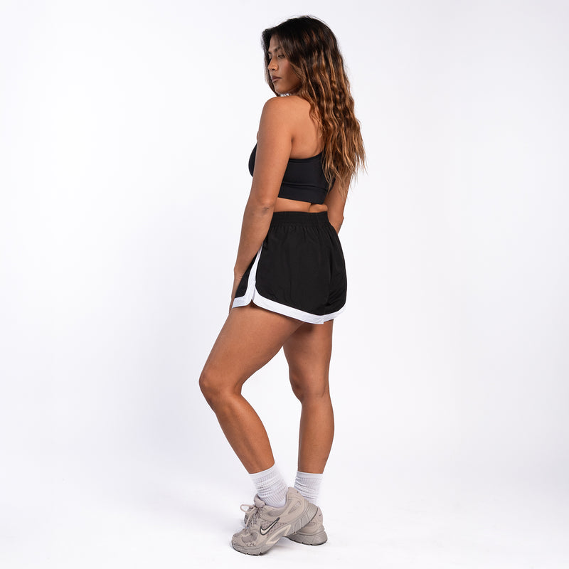 Womens black woven shorts with elastic waistband and white-edged side trim