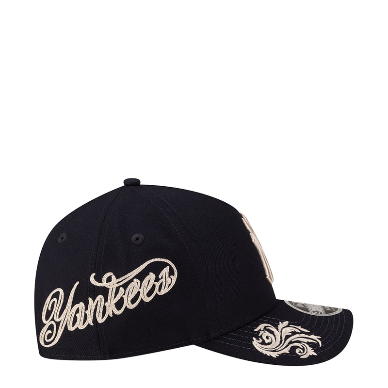 Navy A-frame cap with script Yankees wordmark and decorative side embroidery