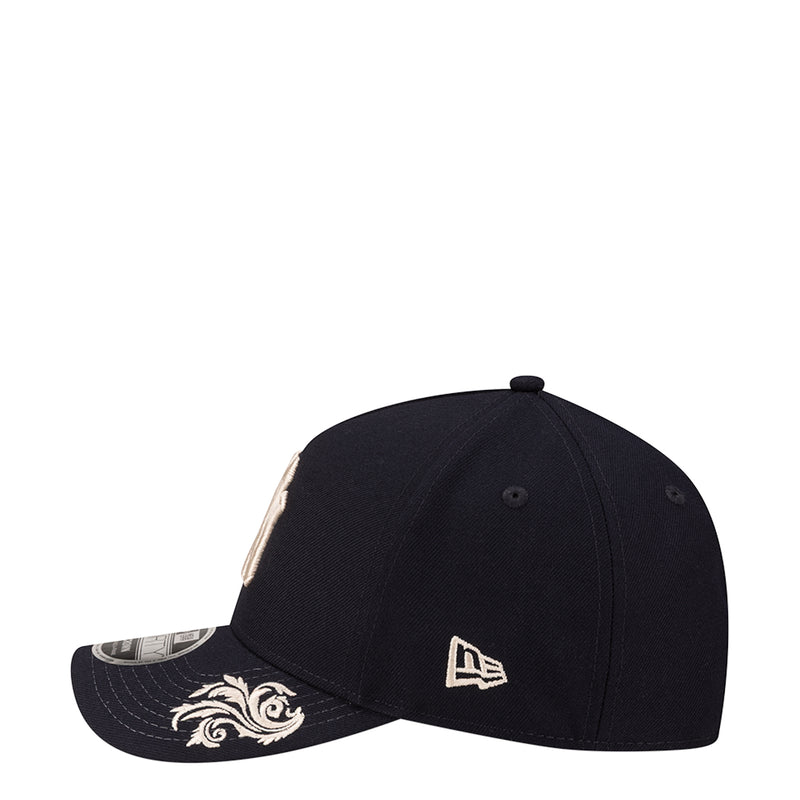 Navy baseball cap with curved brim and Yankees script patch on the side