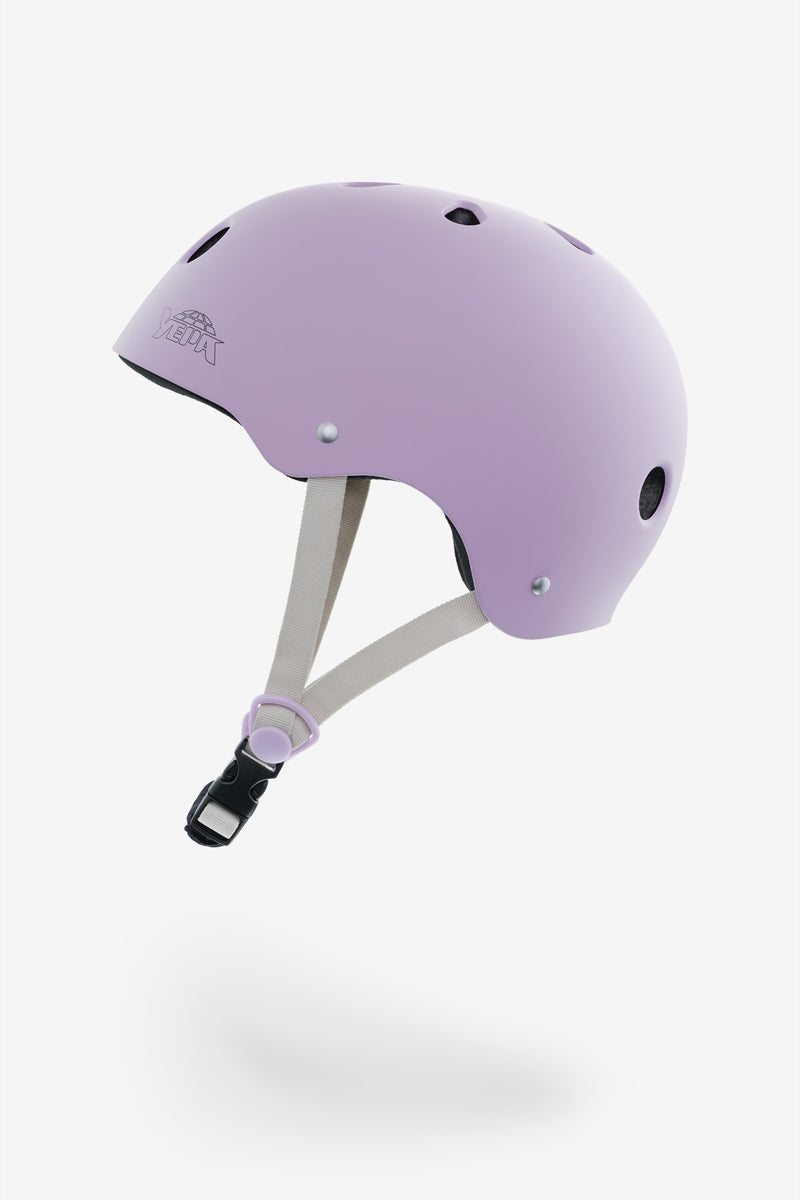 Side view of YEPA T-Shell helmet in matte dusty purple with beige chin strap and buckle