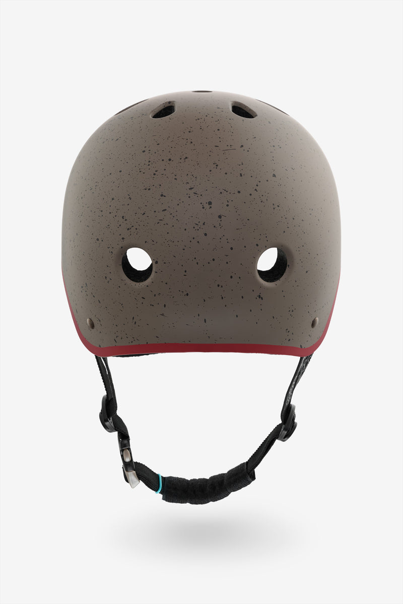 Back view of warm stone speckled YEPA helmet with red trim along the base and the chin strap hanging down.