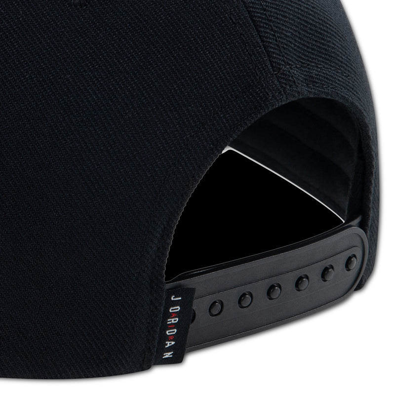 Black dad cap strap and eyelet panel on side, with red Jordan label